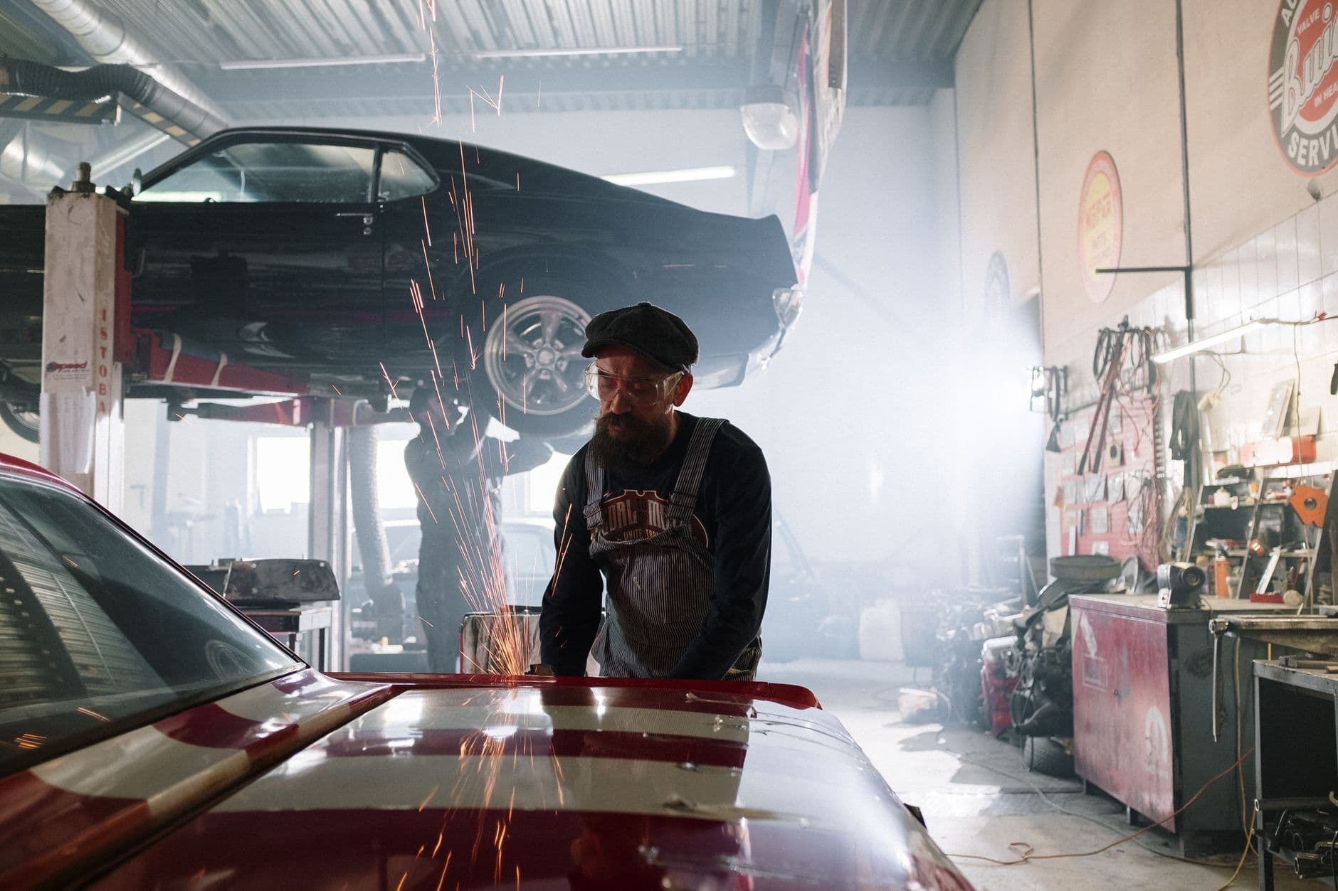 Mechanic servicing a car on a hoist in the A1 workshop